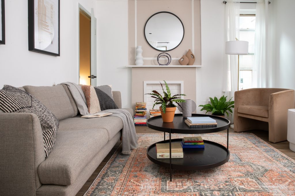 Cozy living room with gray couch and black coffee table, perfect for rental properties