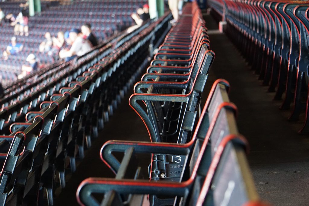 A photograph of a stadium seating section filled with people. 