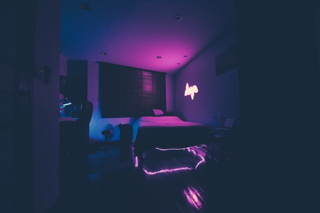 Room with blue and purple neon lighting creating a calming and relaxing atmosphere for reducing anxiety at home.
