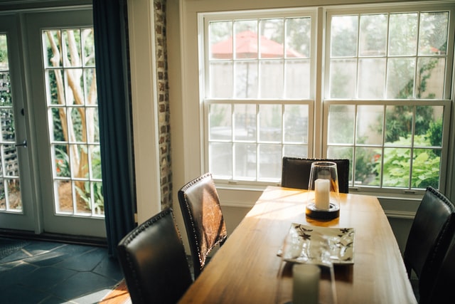 A cozy dining area with soft lighting, featuring a wooden table and chairs. The warm and inviting atmosphere is perfect for relaxing and enjoying a meal with loved ones.