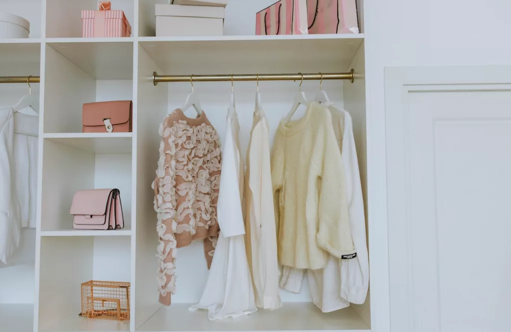 An organized white wooden closet suitable for a rental space, allowing for practical storage solutions.