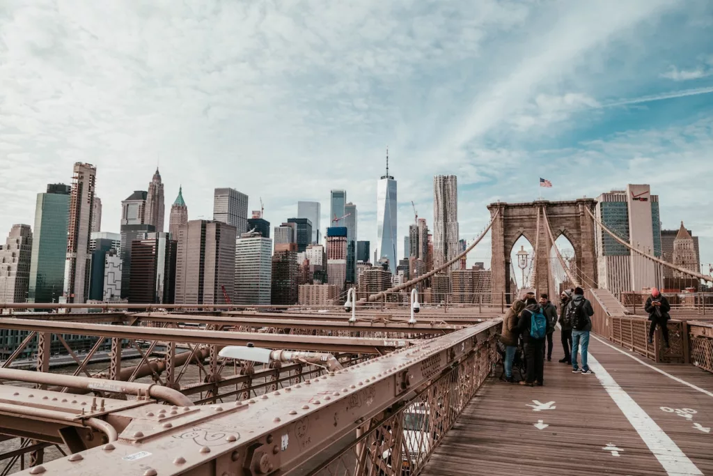 People standing on Brooklyn Bridge, representing the iconic landmark of one of the safest neighborhoods in Brooklyn.