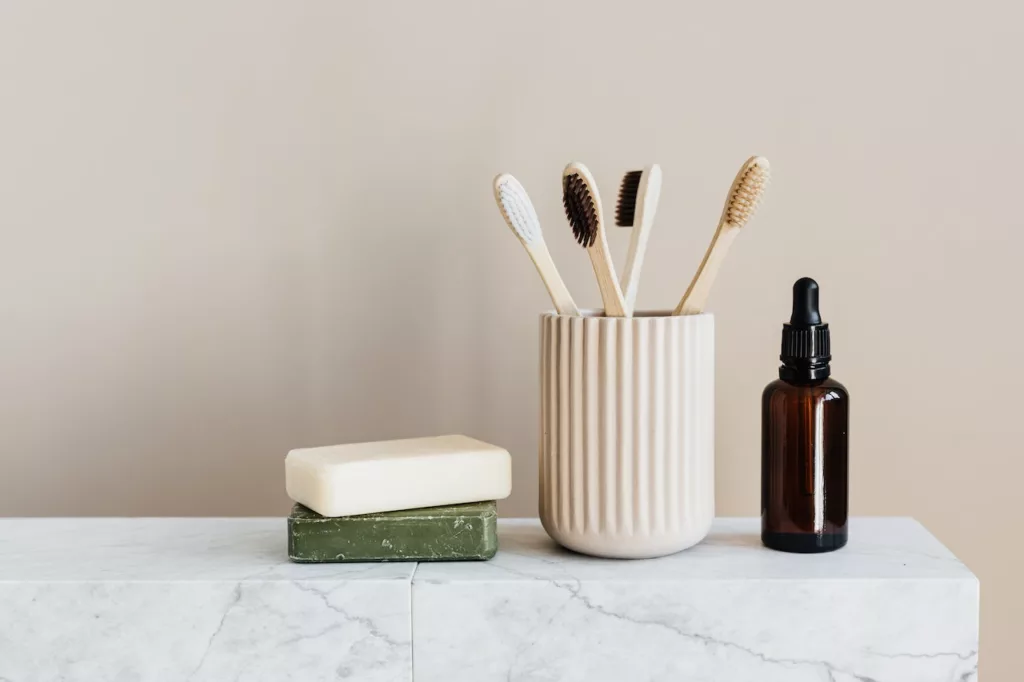 Image of a set of natural and eco-friendly toiletries, placed on a sleek marble table, emphasizing the importance of sustainable choices in apartment living, and providing inspiration for making environmentally conscious choices in everyday life.