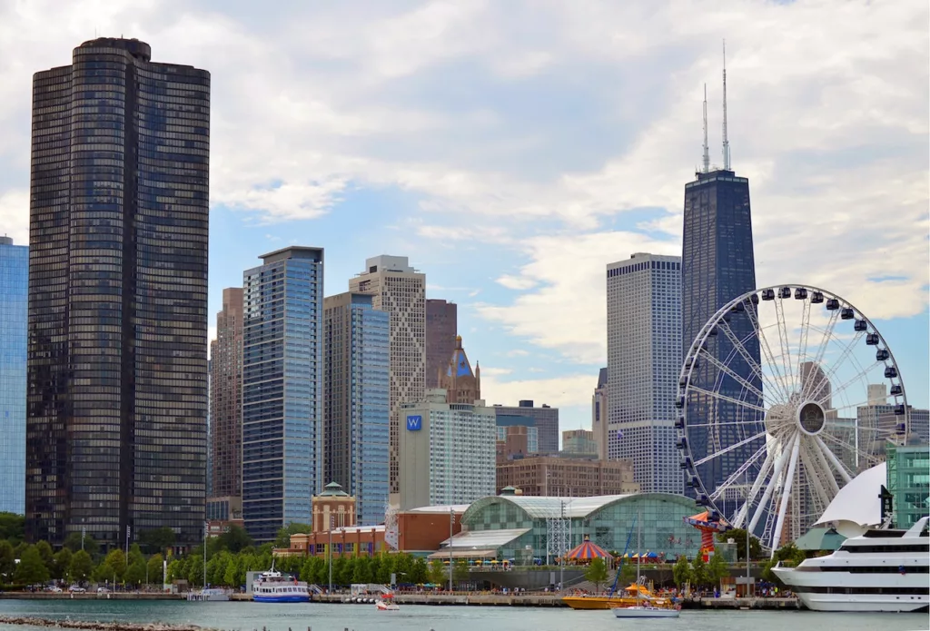 View of Chicago's famous Navy Pier, a top attraction in the city, featuring a bustling boardwalk with stunning views of Lake Michigan, multiple entertainment options, and lively crowds enjoying the vibrant atmosphere.