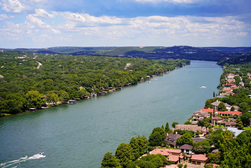 Aerial view of green trees near body of water during daytime photo - Austin, TX