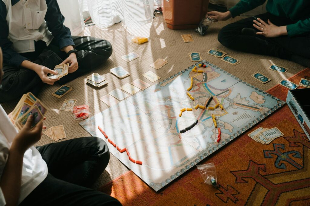 Gather your roommates for an evening of fun and laughter with classic board games! The image above captures friends deeply engaged in a thrilling game, illustrating the perfect setup for a cozy game night. Whether it's strategizing your next move or enjoying some friendly competition, these moments can strengthen bonds and create lasting memories. Board games are a fantastic way to unwind and enjoy each other's company, offering an excellent alternative to digital entertainment. So, pull out your favorite games, gather some snacks, and let the good times roll!