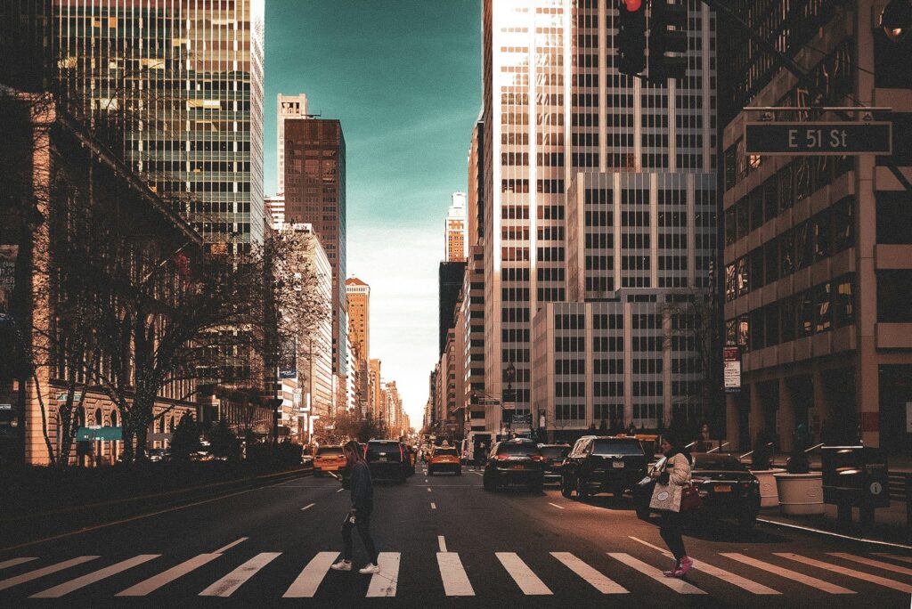 A couple of people that are standing in the Manhattan street photo 