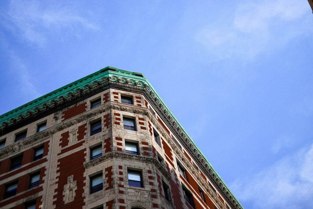 Brown Boston concrete building under blue sky during daytime photo