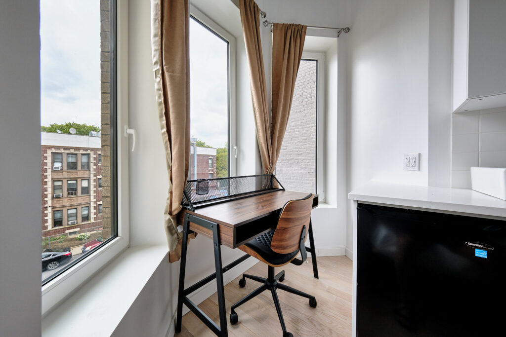 Student room in Manhattan with a full desk by the window