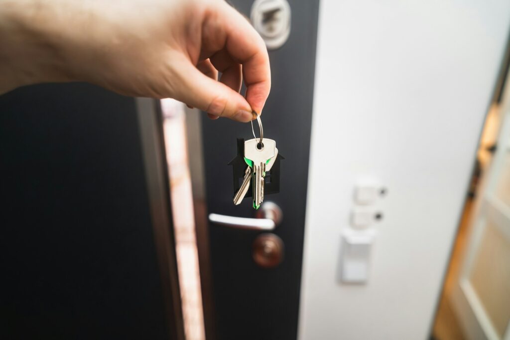 A person is holding a key to a door photo